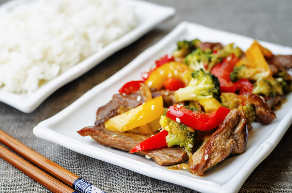 pepper broccoli beef stir fry on a grey background. the toning. selective focus