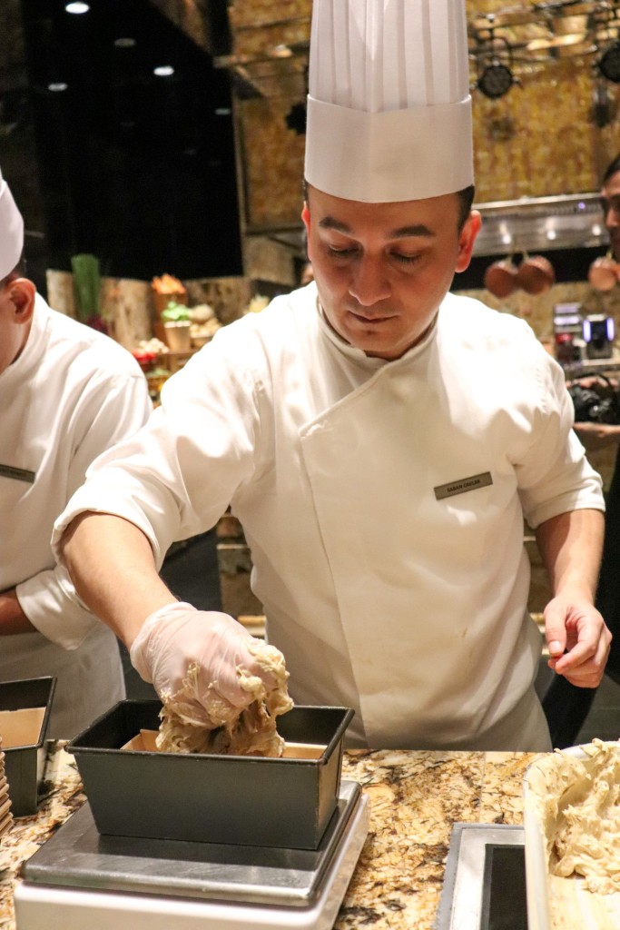 One of the hotel's pastry chefs demonstrates the art of cake mixing.