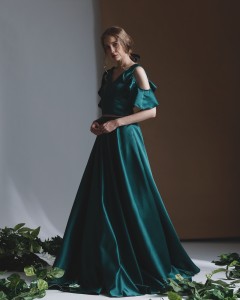 Off-shoulder gown in deep emerald green