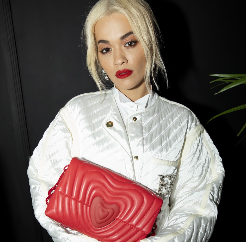 Rita Ora clutching her Heart Bag